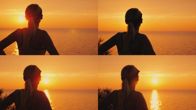 有目的的女运动员在海上看日落，后视