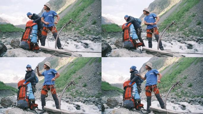 徒步旅行期间，一群游客乘坐绳索穿越了一条暴风雨，快速的山河。