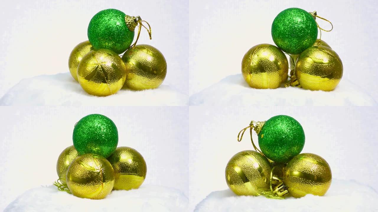 绿色球和三个黄色球在白色表面上旋转