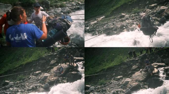 背包沿着缆车在一条快速的山河上移动。