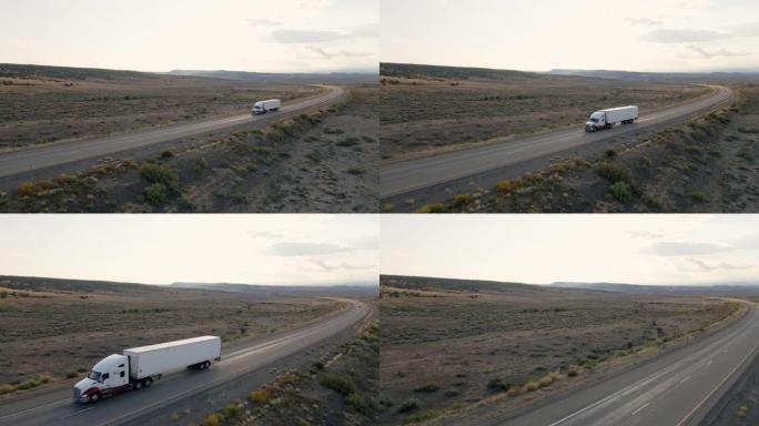 在戏剧性的天空下，半卡车在黄昏时分在犹他州沙漠的高速公路上超速行驶