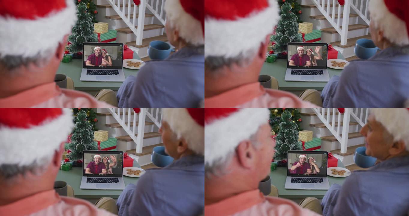 快乐的高加索高级夫妇在圣诞节与成年孩子一起在笔记本电脑上进行视频通话