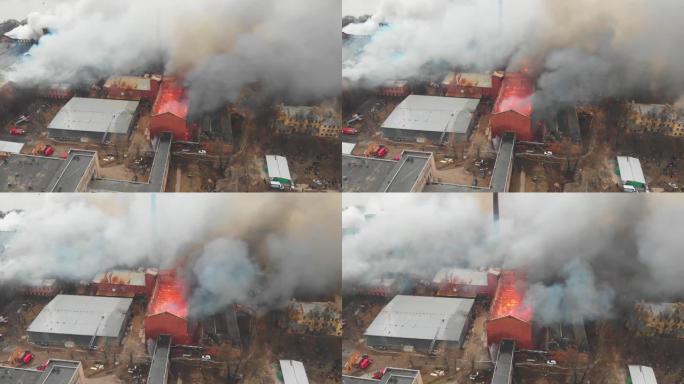 城市发生大规模大火，空中无人机俯视图砖厂大楼着火，地狱火爆炸火焰爆炸，有消防员队伍，纵火，烧毁破坏