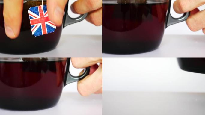 一名男子在白色背景下用带有英国国旗标签的茶包酿造一大杯茶