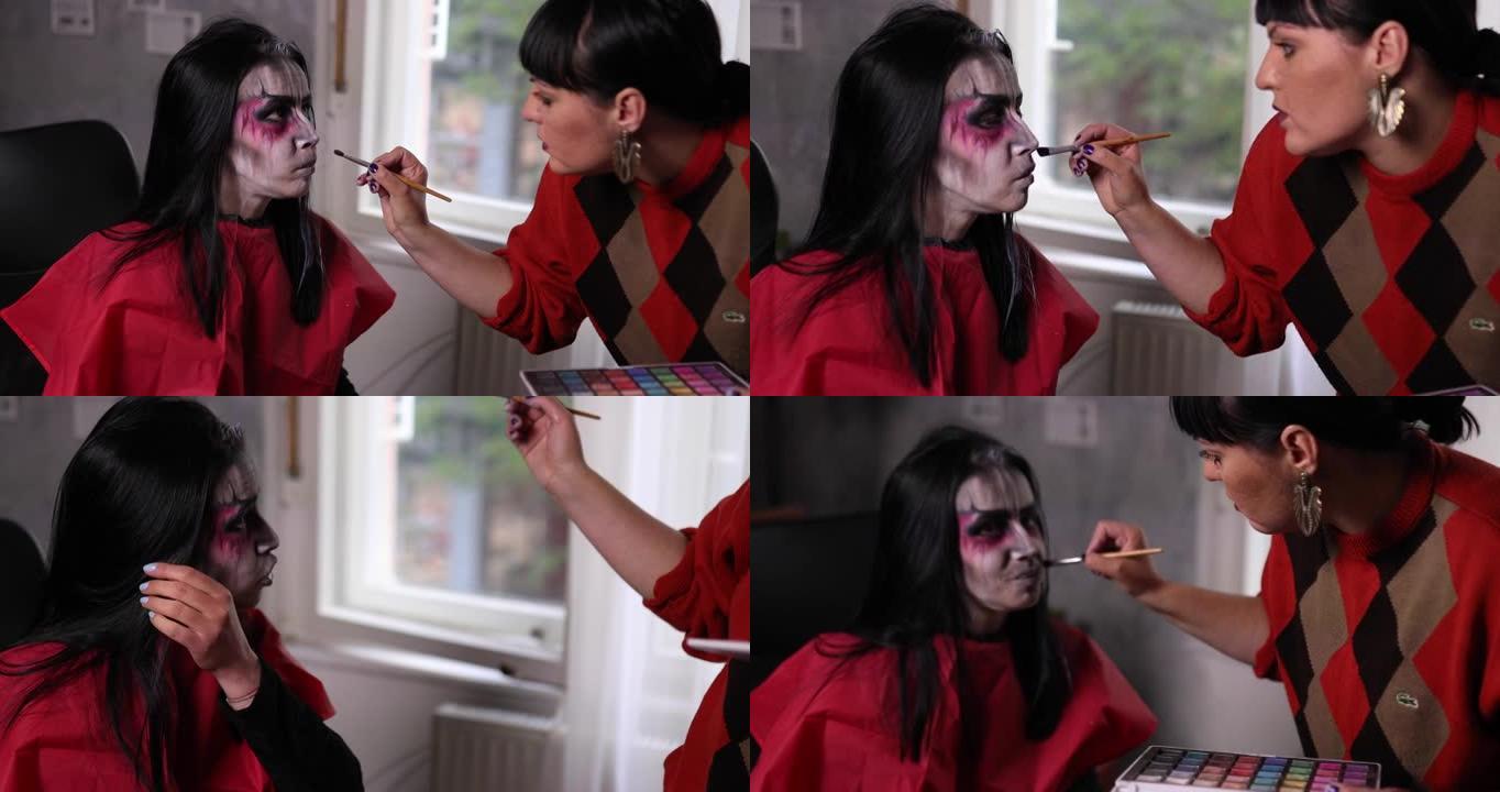 女化妆师使用眼影和她的技能将她的客户伪装成万圣节之夜的吸血鬼