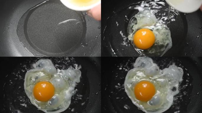 在电锅上从热油杯中倒入煎蛋