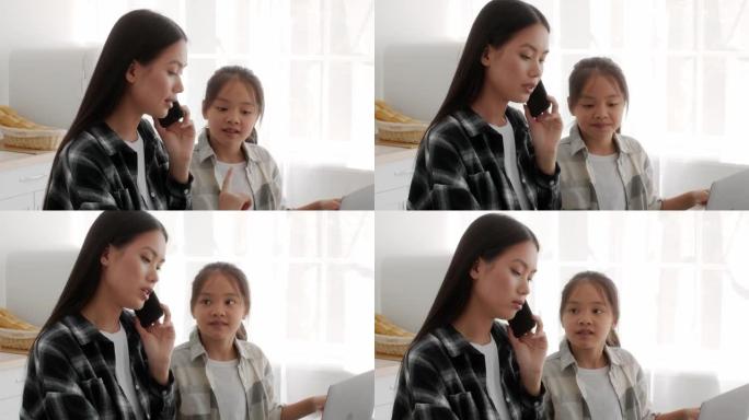忙碌的亚洲自由职业者妈妈无视女儿在室内手机上聊天