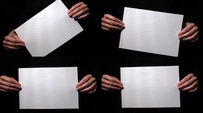 双手握住黑色背景上的空白纸，旋转并保持静止，适用于文本，广告和介绍