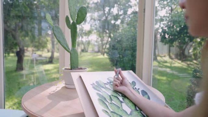 后视镜头拍摄于一个体贴的金发女孩手中旋转笔在绘图纸上沉思，缺乏想法和灵感，绿色工作空间，美术绘画工艺