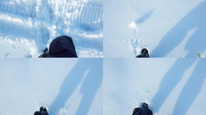 脚在雪地里行走。冬季雪地旅行的游客。