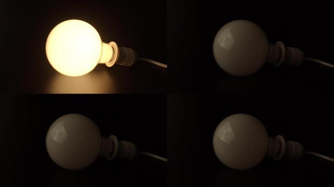 圆形哑光灯泡在深色背景上闪烁。用于住宅、办公室、商业场所照明灯具的节能灯。