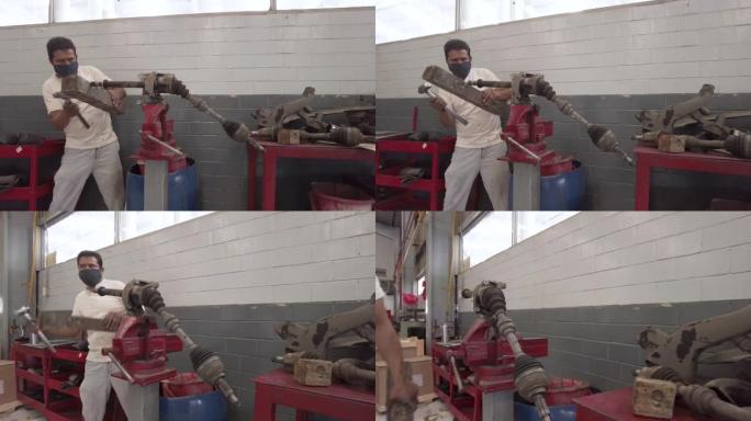 拉丁美洲的拉丁美洲男性机械师在墨西哥的车间车库为汽车的驱动轴提供服务