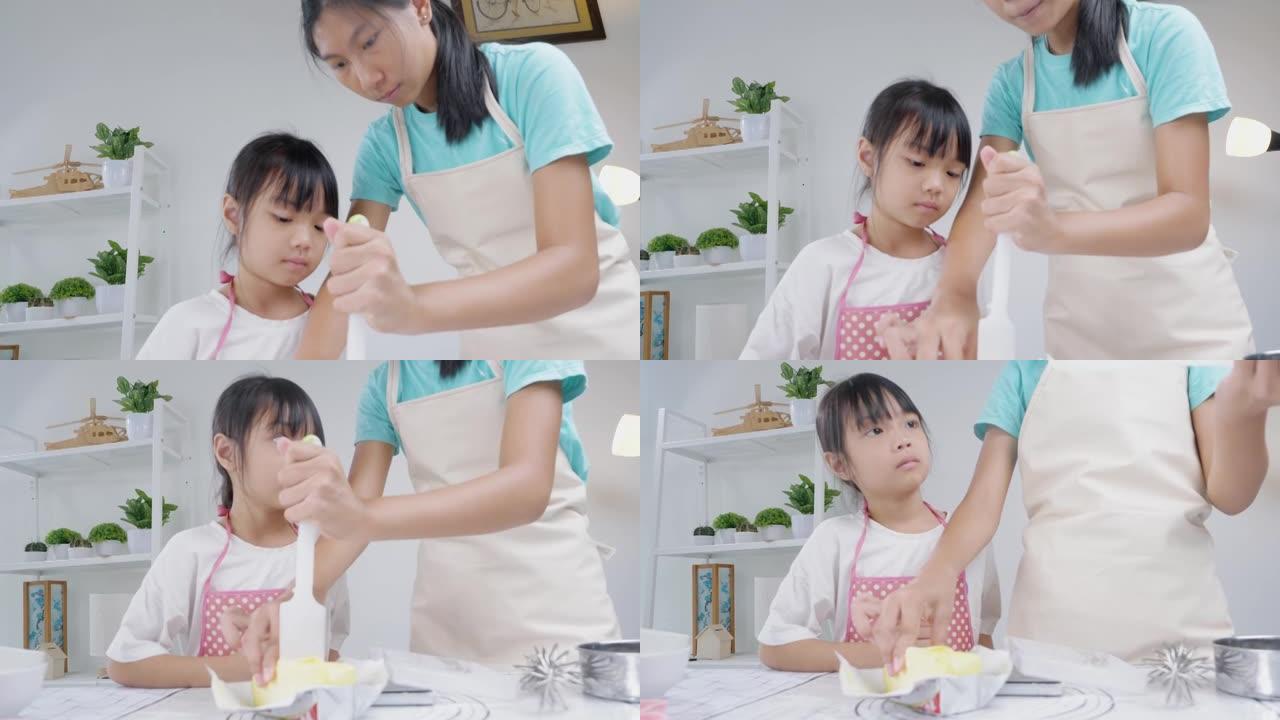 亚洲儿童在家里一起烤饼干之前测量黄油准备，生活方式概念。