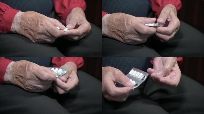 一位老妇人的手拿着一包药片，拆开几颗吃药用的药片