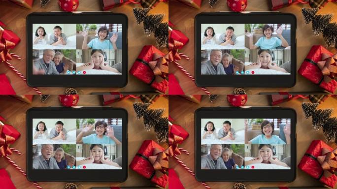 亚洲家庭关系的视频蒙太奇结合人们挥舞着双手和幸福一起微笑看着平板电脑上的相机躺在木地板上，带有圣诞节
