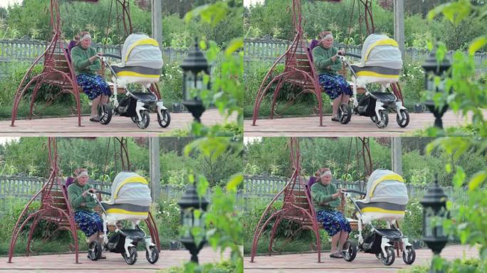 曾祖母带着婴儿在房子的院子里的婴儿车里散步。
