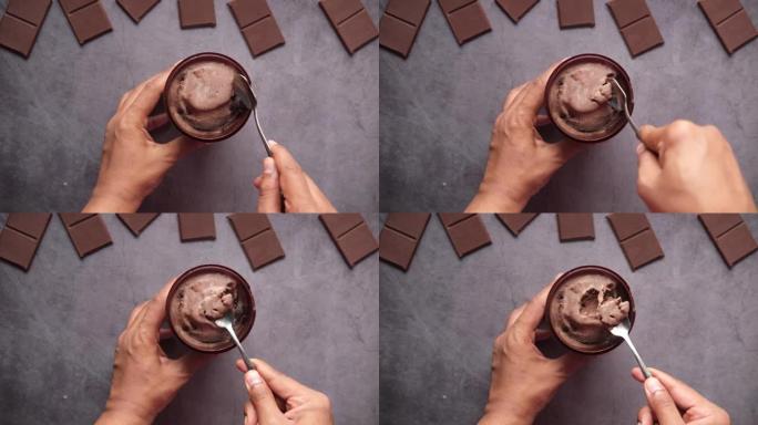 男人在容器中吃巧克力味冰淇淋的俯视图