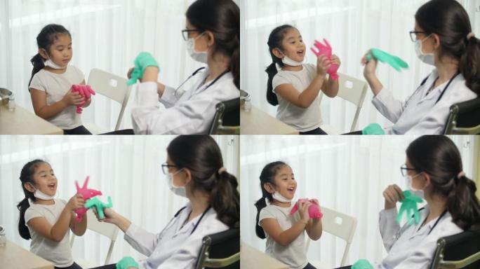 医生给小女孩打疫苗前和小女孩玩耍，注射冠状病毒疫苗