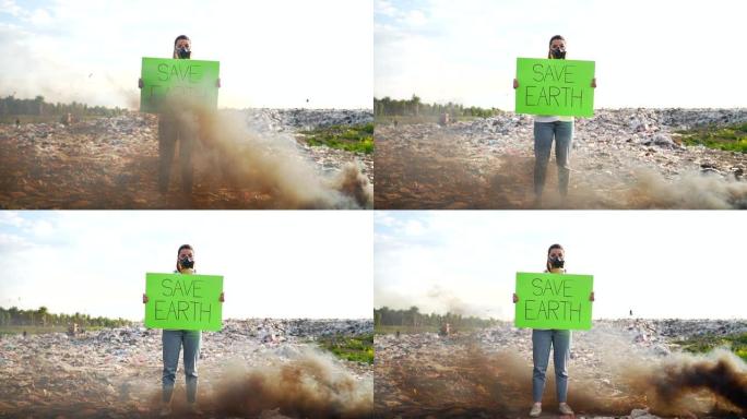 手握海报的年轻女性活动家save earth站在垃圾填埋场中间，戴着呼吸器脸