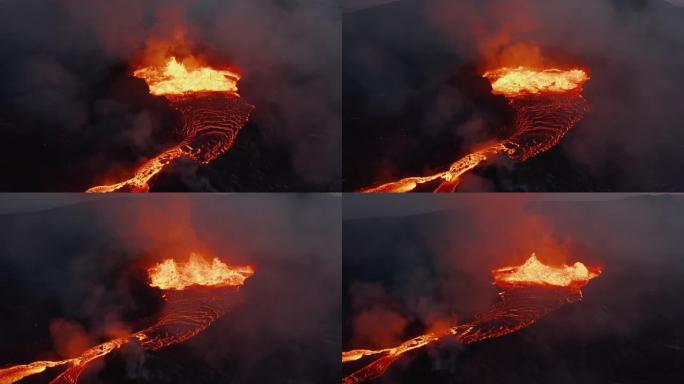 从火山火山口流出的熔融熔岩的滑动和平底锅射击。疯狂沸腾的岩浆溅到高处。法格拉达尔斯福杰尔火山。冰岛，