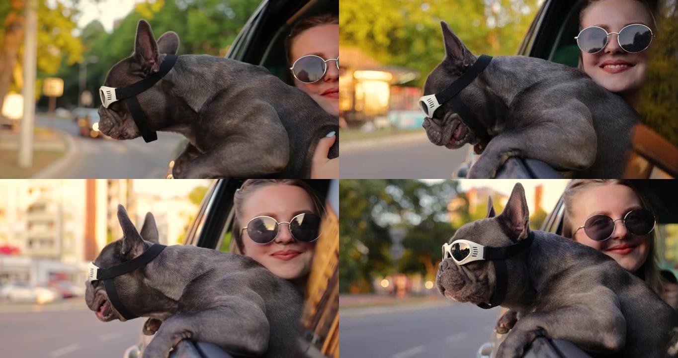 关心和可爱的女孩，抱着她的狗，这样他就可以在开车时带着防护眼镜探索城市
