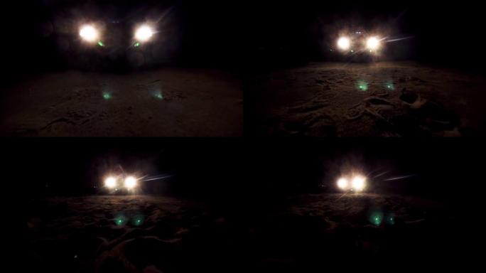 夜间汽车的前灯，照亮前方的沙面