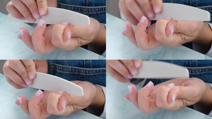 女性的手在修指甲。指甲护理，自我护理。在家的时候自己修指甲。Diy。修指甲的工具
