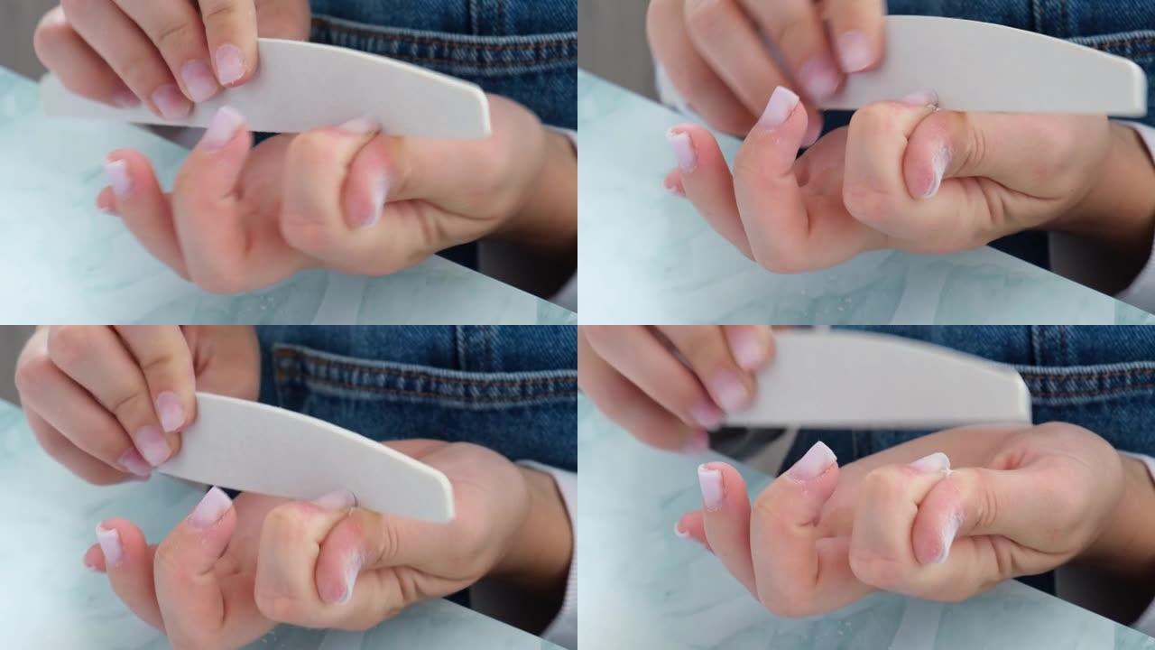 女性的手在修指甲。指甲护理，自我护理。在家的时候自己修指甲。Diy。修指甲的工具