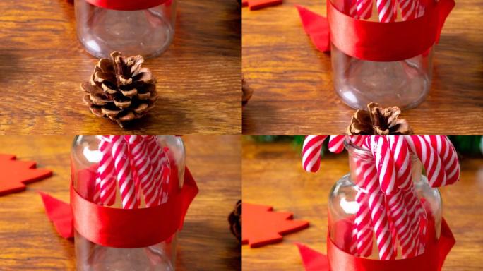 木制背景上的糖果和松果圣诞装饰品的组成