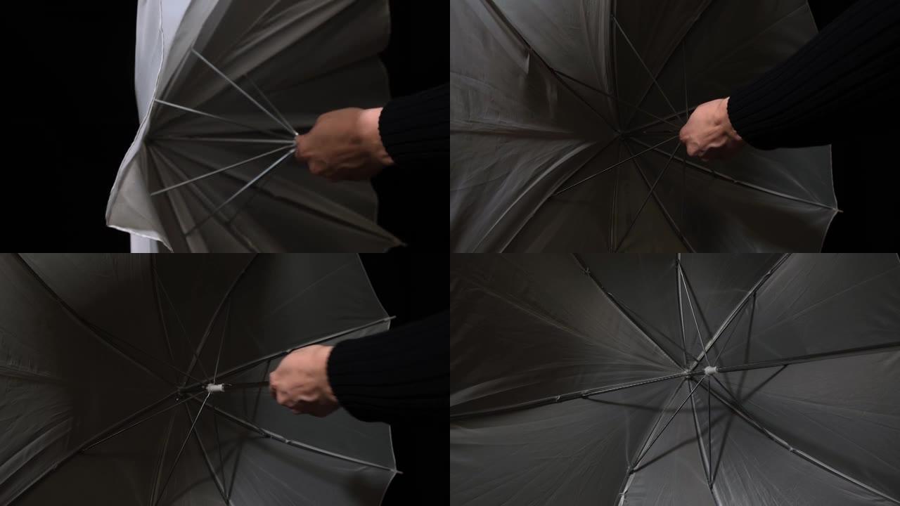 一个人在黑暗、庇护和保护概念中打开白伞