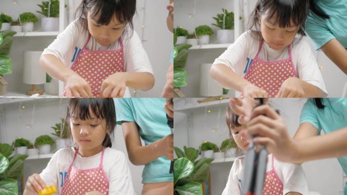 亚洲女孩拍摄视频她的妹妹在家制作自制饼干，用于病毒视频或在家TikTok，新一代概念的时尚生活方式。