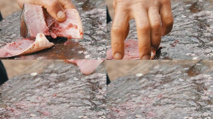 一个男人一个渔夫把一条活蹦乱跳的大鱼切成碎片。清洗淡水鱼以进一步烹饪