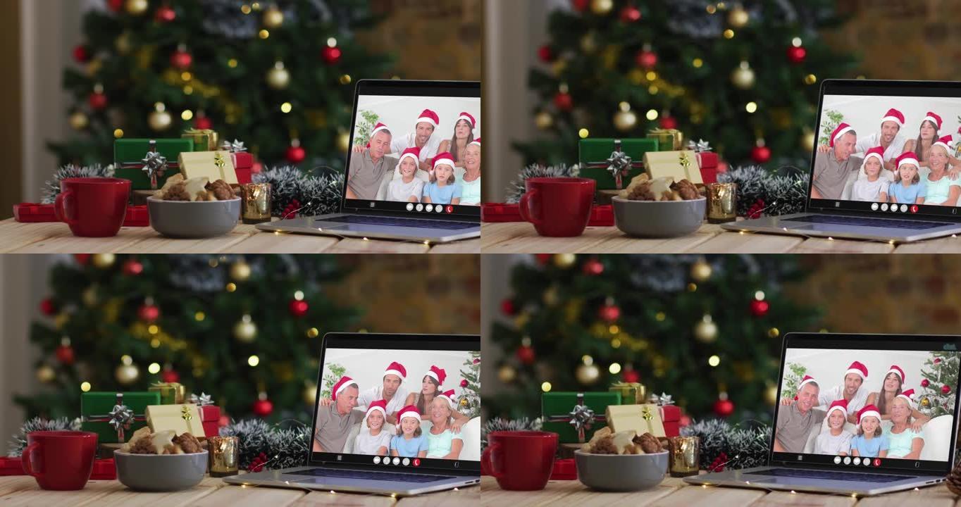 幸福的家庭戴着snata帽子在笔记本电脑上的视频通话，带有圣诞节装饰品和树木