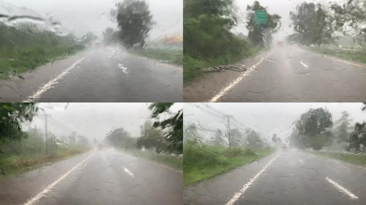 天气和交通在路上在大雨中，前挡风玻璃雨刷一直在工作