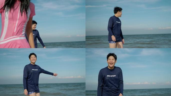 穿着泳衣的快乐亚洲儿童在度假期间一起在海滩上享受海浪。