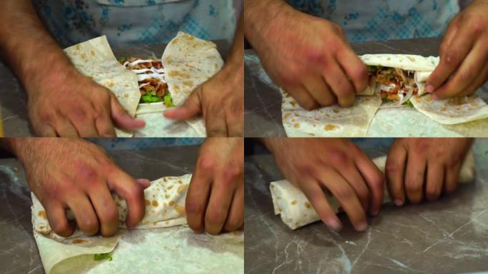 男人的手把蔬菜和鸡肉放在皮塔饼上煮面包卷，