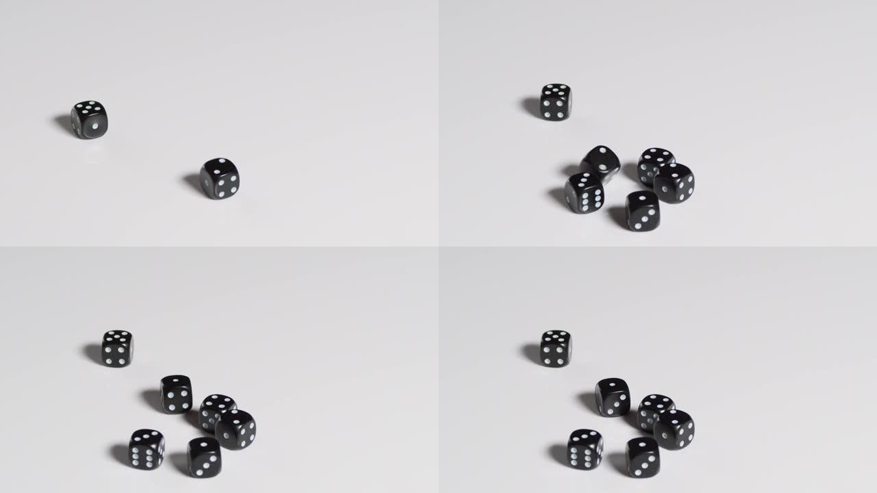六个黑色骰子在慢动作中滚动