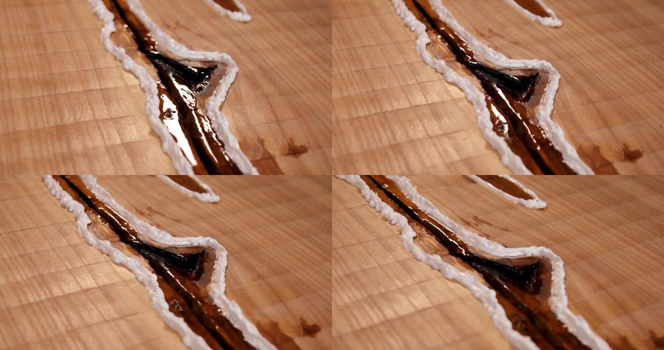 干环氧树脂在木桌中的特写。工艺树脂和木桌的制作工艺