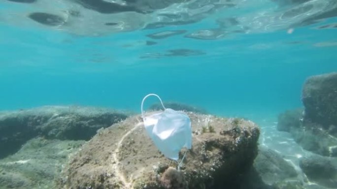 二手外科口罩漂浮在海洋生态系统上，covid19环境污染