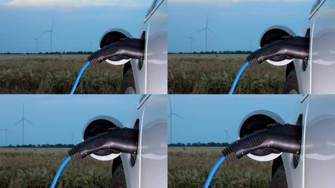 风车在麦田里产生能量供电动汽车充电