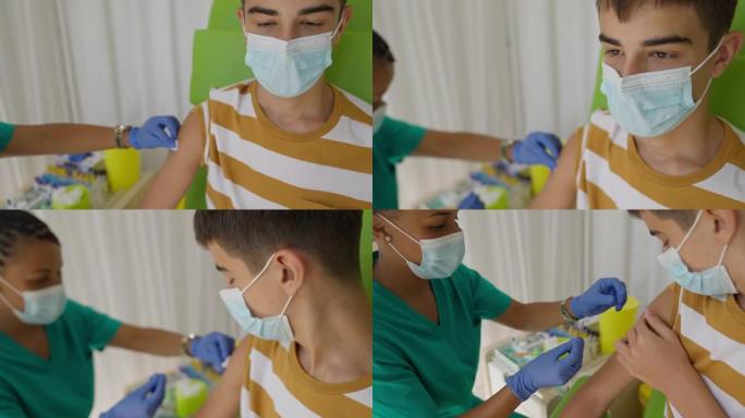 接种新冠疫苗后，护士给一名少年的手臂贴创可贴