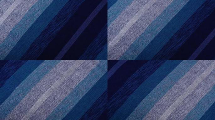 手摇传统的摩洛哥床罩，由仙人掌丝绸和羊毛制成，呈蓝色阴影。