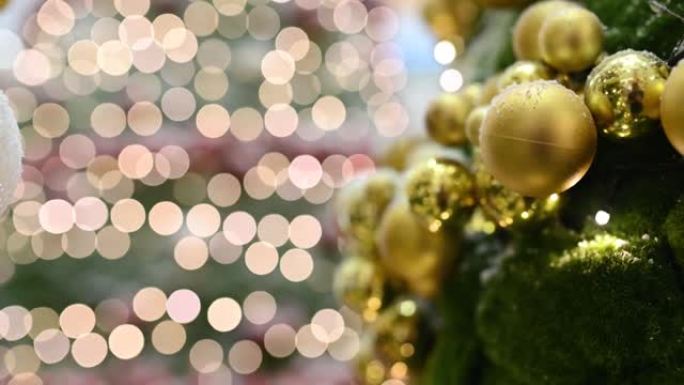节日装饰的室内圣诞发光二极管灯的特写镜头，模糊的闪闪发光的童话背景上有明亮的金色球。