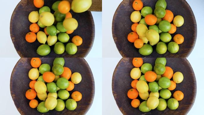 柑橘类水果，柠檬，橘子，放在古董木碗中。维生素c，健康清爽，天然有机食品生活方式背景。