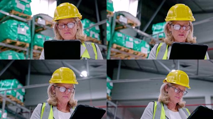 一个成熟女人在仓库工作时使用数字平板电脑的4k视频片段