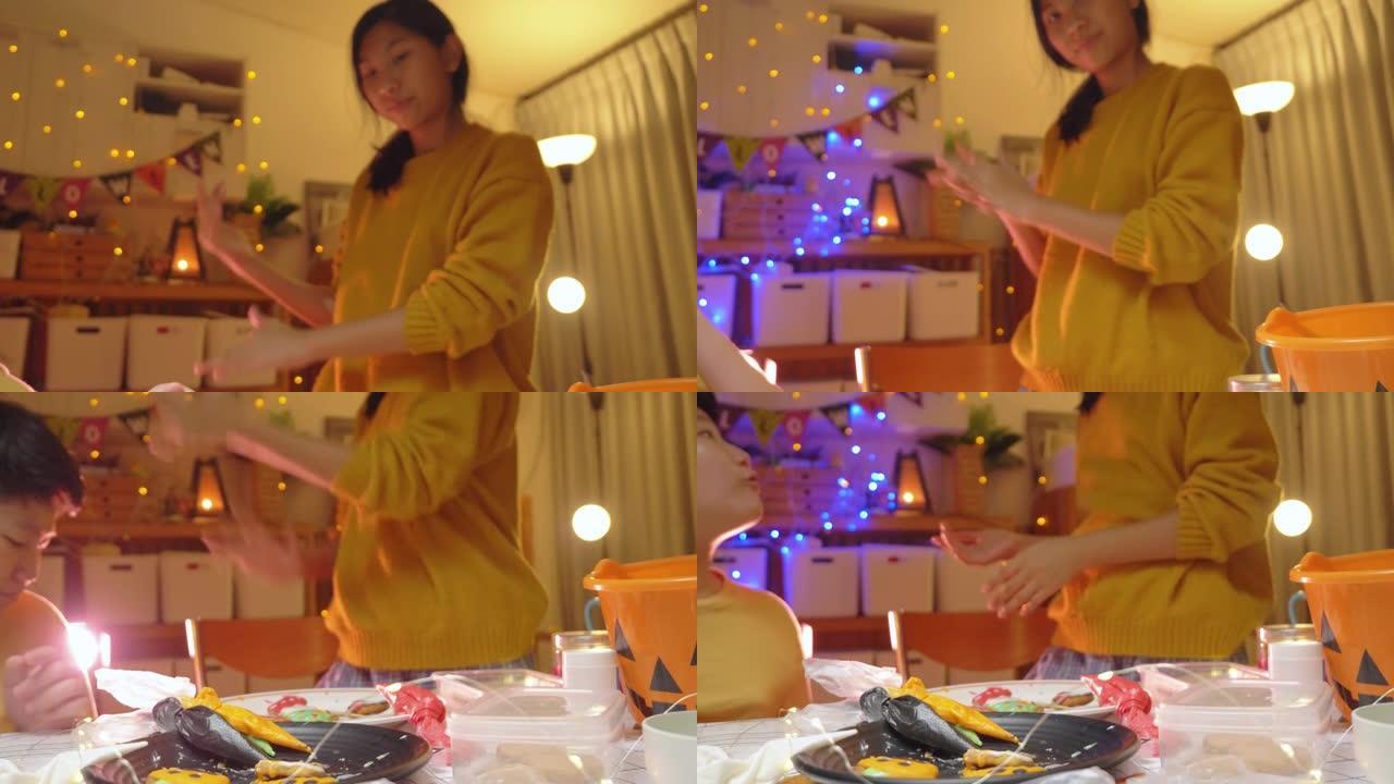 亚洲儿童在晚上在家一起装饰糖衣饼干，万圣节的生活方式概念。