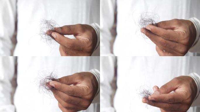 男人拿着他的头发特写