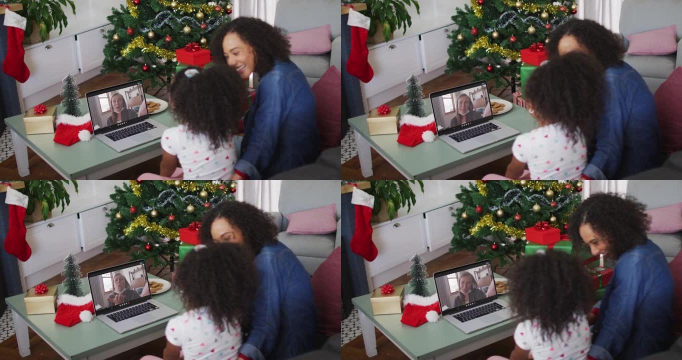 圣诞节期间，非裔美国母女在家里的笔记本电脑上进行录像
