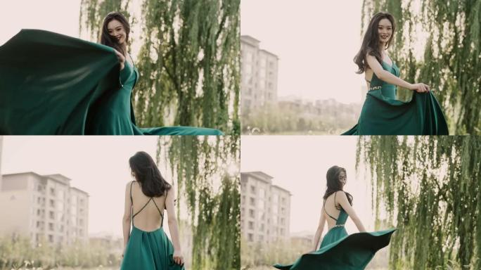 年轻美丽的亚洲女性穿着绿色的裙子，在夕阳中奔跑，穿着晚礼服的中国新娘