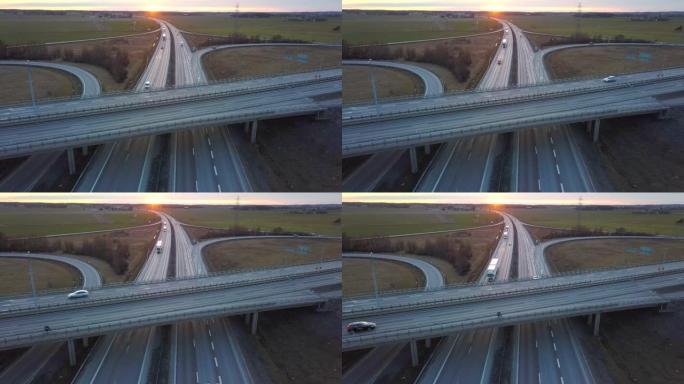 高速公路交叉口与行驶中的交通车的鸟瞰图。